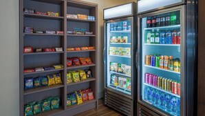 A snack and beverage refrigerator stocked with various snacks and drinks. - Holiday Inn Express And Suites Dahlonega University Area, an IHG Hotel (Dahlonega)