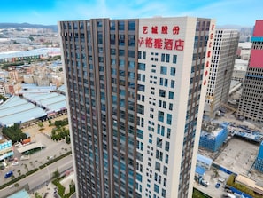 Un edificio alto con un cartel llamativo que indica que es un hotel.
