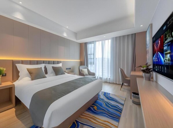A modern hotel room with a large bed, a flat-screen TV, a desk, and a window with curtains. - GYA Kunming Zijin Center Xiaodong Village Metro Station Hotel (Kunming)