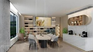 A modern interior with a dining area, kitchen, and bookshelves. - VX Xiamen Siming District Huandao Road Hotel (Xiamen)