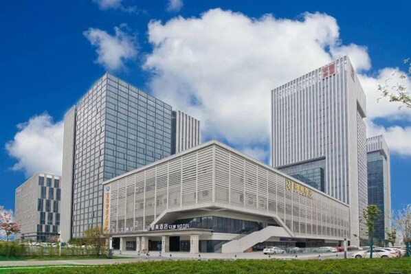 A modern hotel with a prominent entrance and a large glass facade. - Gem Hefei High-tech Zone China Sound Valley Hotel (Hefei)