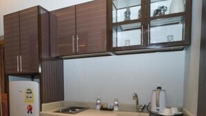 A compact kitchen with a refrigerator, microwave, sink, and cabinets. - Maset Al Masem Al Khobar (Al Khobar)