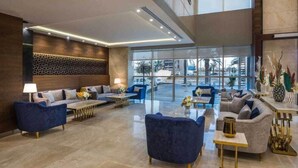 A spacious lobby with a modern design, featuring a mix of seating areas and a large glass entrance. - Elian Hotel (Riyadh)