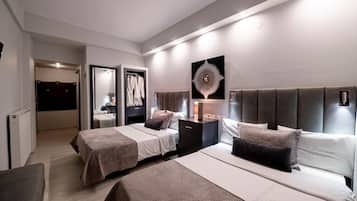 A modern hotel room with two beds, a walk-in closet, and a large mirror.