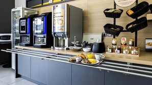 A breakfast bar with a coffee machine, a kettle, and a display of bread baskets.