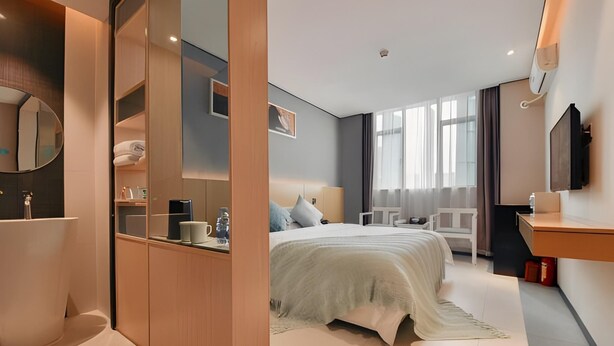 A modern hotel room with a bed, bedside table, and a large window. - Shangyuan Hotel (Guangzhou)