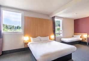A hotel room with two beds, a large window, and a view of the outdoors. - B&B Hotel Ales Pole Mecanique (Saint-Martin-de-Valgalgues)