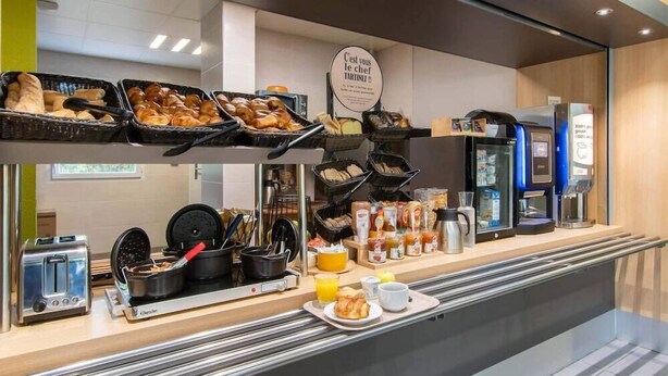 A breakfast buffet with various pastries, a coffee machine, and a toaster. - B&B Hotel Ales Pole Mecanique (Saint-Martin-de-Valgalgues)