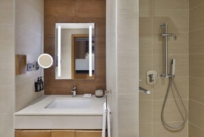 A modern bathroom with a white sink, a mirror, a handheld showerhead, and a towel rack. - Dusitd2 Naseem Resort Jabal Akhdar (Sayq)
