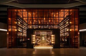 A modern building with a central entrance flanked by bookshelves. - Mumian Hotel Beijing Daxing Airport (Daxing)