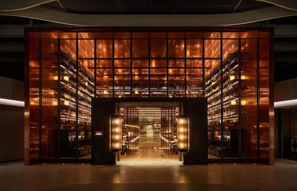 A modern building with a central entrance flanked by bookshelves. - Mumian Hotel Beijing Daxing Airport (Daxing)