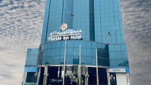 A tall, modern hotel building with a prominent sign for the Florida Inn Hotel. - Florida Inn Najran (Nejran)