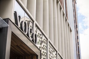 A building facade with large letters spelling 'Voco' and a patterned window design. - Voco Auckland City Centre (Auckland)