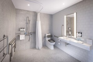 A modern bathroom with a shower, toilet, and sink, equipped with grab bars and a large mirror. - Holiday Inn Express Auckland City Centre (Auckland)