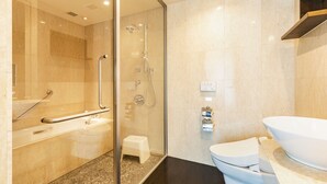 A modern bathroom with a glass-enclosed shower, a white sink, and a large white bathtub. - Koko Hotel Premier Hakata (Fukuoka)