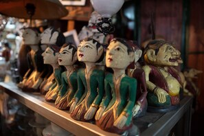A row of wooden figurines on a shelf. - Ommaya Hotel and Resort (Baki)