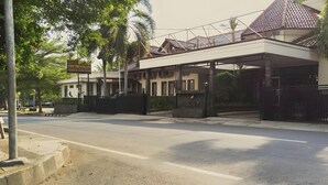 A modern building with a covered entrance and a gated driveway. - The Priangan Boutique Hotel (Ciamis)