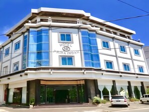 A multi-story hotel with a modern facade, large windows, and a prominent sign reading "HOTEL PIMAH INAH". - Hotel Prima Indah (Sibolga)