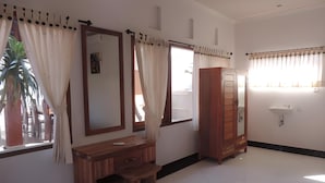 A room with a wooden desk, a wardrobe, and a mirror. - Pakels Bali Villas (Karangasem)