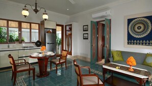 A dining area with a round table, chairs, and a decorative centerpiece.
