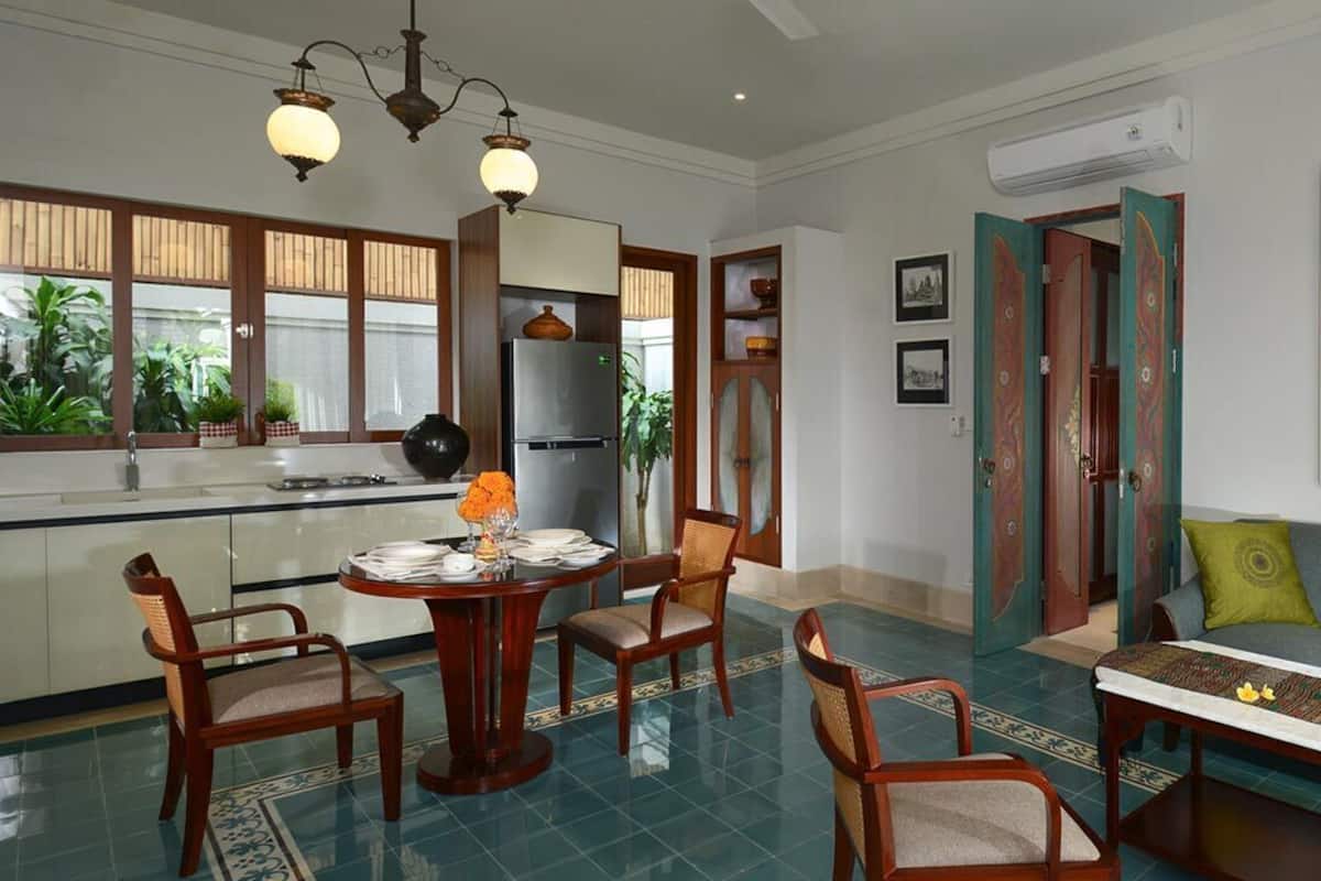 A dining area with a round table, chairs, and a decorative centerpiece.