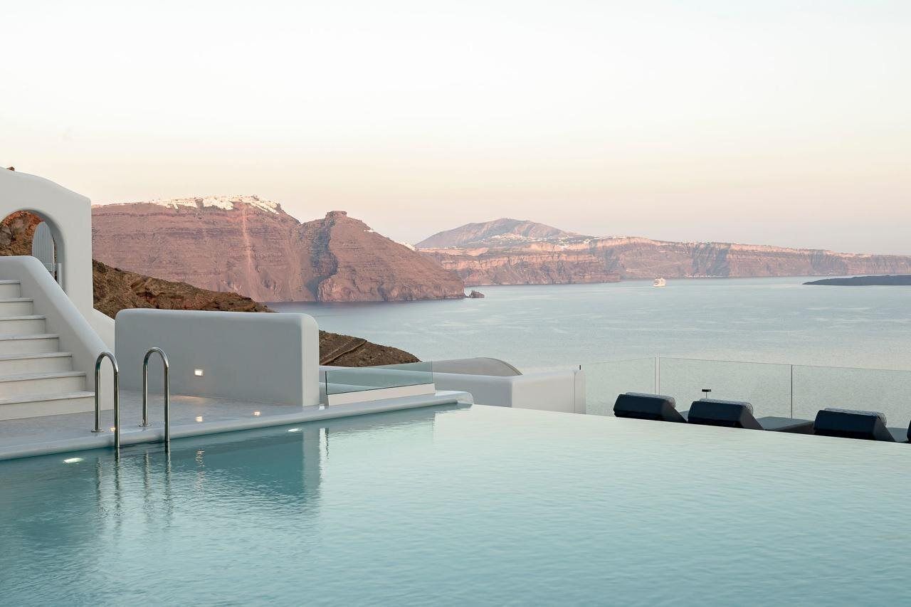 An infinity pool with a view of cliffs and the sea.