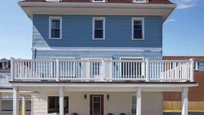 A two-story building with a balcony and a covered porch. - Wildwood Inn, a Travelodge by Wyndham (Wildwood)