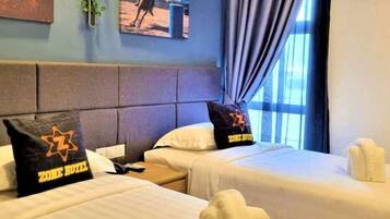 A hotel room with two beds, a headboard, a window with curtains, and a painting on the wall.