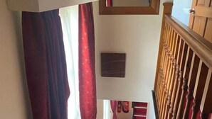 A staircase with red carpeted steps leading to a landing. - The Knighton Hotel by Payman Club (Knighton)