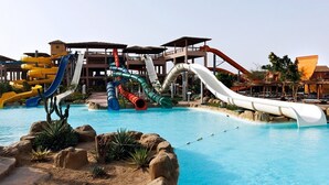 A water park with multiple slides and a pool.