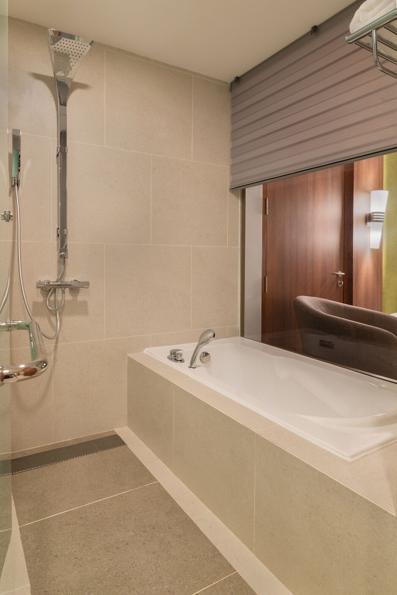 A modern bathroom with a shower, a bathtub, and a toilet.