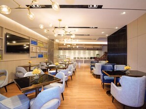 A hotel lobby with a bar area, seating arrangements, and a staircase. - Echarm Hotel (Guangzhou)