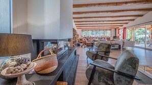 A spacious living area with a fireplace, comfortable seating, and large windows. - Grimaud amazing villa with a swiming pool (GRIMAUD)