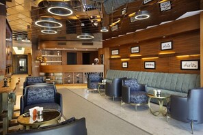 A modern lobby with a central seating area, a reception desk, and framed artwork on the walls. - Buem Hotel Kosuyolu (Istanbul)