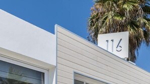 A modern building with a sign reading "Centosedici" and a number "116" above the entrance. - Hotel Centosedici (Terracina)