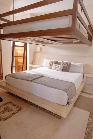 A bunk bed with a wooden frame, a white mattress, and a grey blanket.