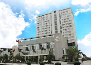 A modern hotel building with a prominent sign reading "Central Hotel."