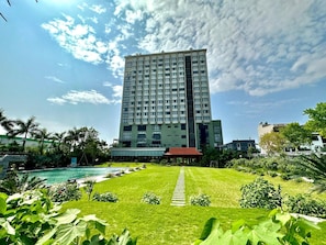 A tall hotel with a central courtyard, a swimming pool, and surrounding greenery. - Central Hotel Thanh Hoa (Thanh Hoa)