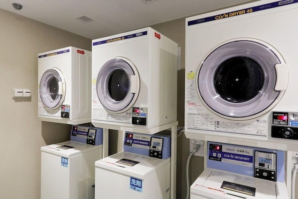 A row of stacked laundry machines with control panels, each labeled with "CO/N DRYER 45". - JR Inn Sapporo N2 (Sapporo)