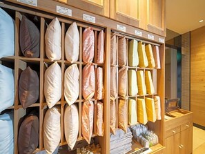 A display of pillows in a store with wooden shelving. - Super Hotel Okayama (Okayama)