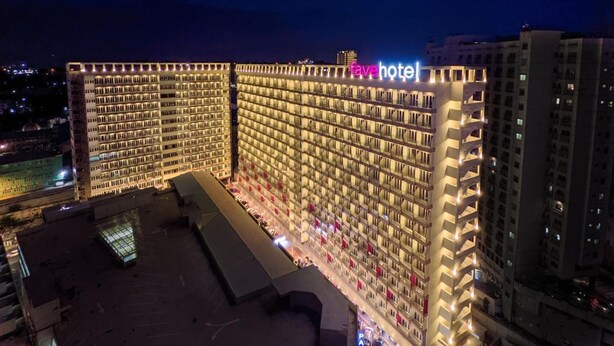 A hotel with a large, illuminated facade and a rooftop area. - Favehotel Nagoya (Batam)