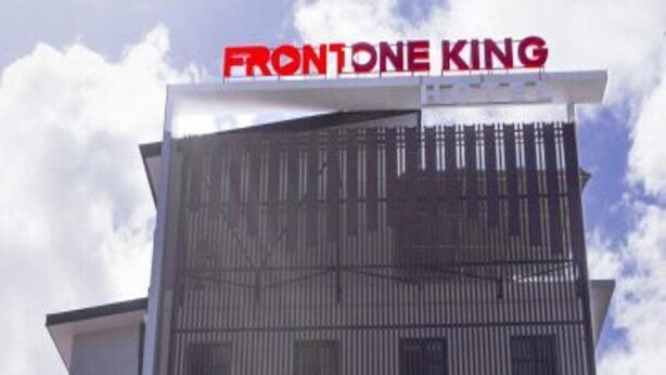 A building with a sign reading "FRONTONE KING" at the top. - Front One King Hotel Tuban (Tuban)