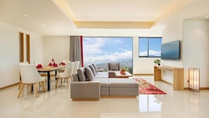 A modern living room with a large window, a dining area, and a TV. - Da Nang Mikazuki Japanese Resorts and Spa (Da Nang)