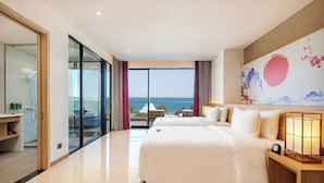 A hotel room with a large bed, a bedside table with a lamp, and a view of the sea through a glass door. - Da Nang Mikazuki Japanese Resorts and Spa (Da Nang)