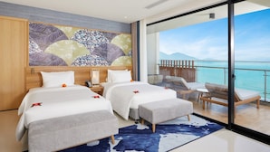 A hotel room with two beds, a large window with a view of the sea, and a balcony with seating. - Da Nang Mikazuki Japanese Resorts and Spa (Da Nang)