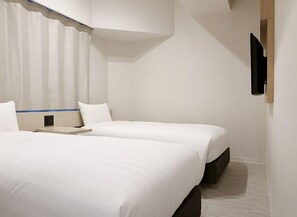 A hotel room with two beds, a flat-screen TV mounted on the wall, and a window with curtains. - Hotel Mid in Kuramae Ekimae (Tokyo)