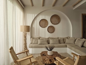 A modern living room with a sofa, armchairs, a coffee table, and a lamp. - Lesante Cape Resort & Villas (Zakynthos)