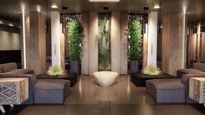 A modern lobby with a central seating area, wooden accents, and vertical greenery. - Nema Design Hotel and Spa - Adults Only (Hersonissos)