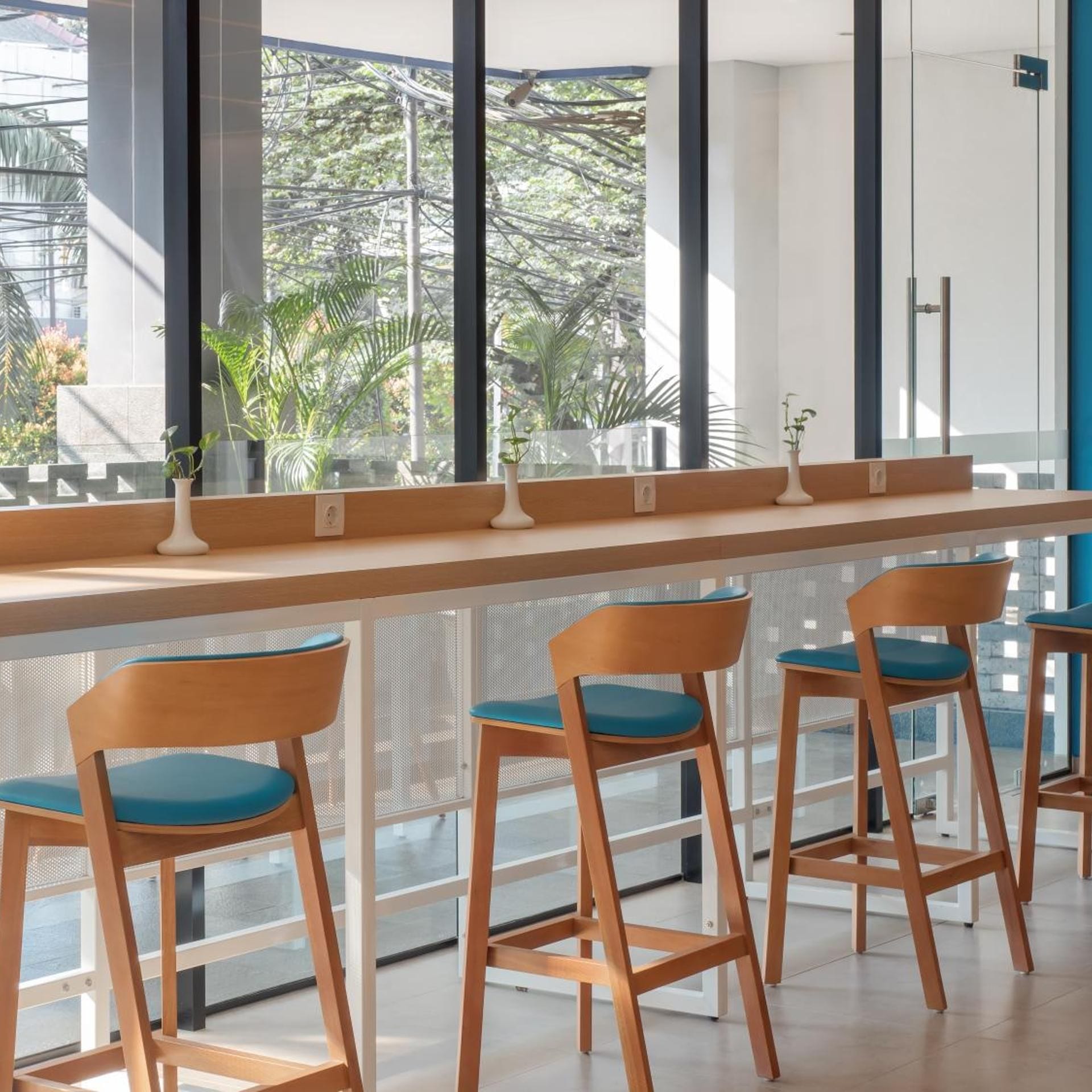 A bar area with wooden chairs and a long counter.
