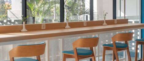 A bar area with wooden chairs and a long counter.